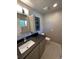 Modern bathroom features granite counters, a sleek vanity, and a stylish mirror cabinet at 6176 S Adams Dr, Centennial, CO 80121