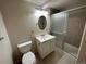 Bathroom featuring a vanity, toilet, and shower with glass doors at 6176 S Adams Dr, Centennial, CO 80121