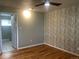 Spacious bedroom with light hardwood floors and an accent wall at 6176 S Adams Dr, Centennial, CO 80121