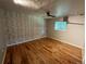 Spacious bedroom with hardwood floors, a ceiling fan, and a large window at 6176 S Adams Dr, Centennial, CO 80121