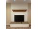 A close-up of a fireplace featuring a wooden mantle and white brick at 6176 S Adams Dr, Centennial, CO 80121