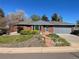 Charming brick home with manicured front yard and cozy, inviting curb appeal on a sunny day at 6176 S Adams Dr, Centennial, CO 80121