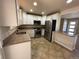 Updated kitchen featuring granite countertops, stainless steel appliances and white cabinetry at 6176 S Adams Dr, Centennial, CO 80121