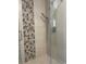 Modern shower featuring a stylish chevron accent and sleek fixtures at 6176 S Adams Dr, Centennial, CO 80121