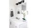 Bathroom vanity with modern lighting and decorative orchid at 6842 W Eldorado Pl, Lakewood, CO 80227
