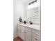 Bright bathroom features a white vanity with marble countertop, modern fixtures, and stylish decor at 6842 W Eldorado Pl, Lakewood, CO 80227