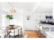 Bright dining area features an oval table, modern chairs, wood floors, and seamlessly connects to the kitchen at 6842 W Eldorado Pl, Lakewood, CO 80227
