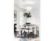 Elegant dining area featuring a round table, modern lighting, and stylish decor at 6842 W Eldorado Pl, Lakewood, CO 80227