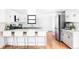 Bright, renovated kitchen with white cabinets, stainless appliances, and counter seating at 6842 W Eldorado Pl, Lakewood, CO 80227