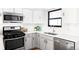Updated kitchen showcasing stainless steel appliances, subway tile backsplash, and quartz countertops at 6842 W Eldorado Pl, Lakewood, CO 80227