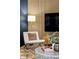 This stylish living room features wood slat wall, a modern chair, and elegant decor at 6842 W Eldorado Pl, Lakewood, CO 80227