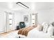 Cozy bedroom with plush bedding, lots of natural light, and stylish accent chair at 6842 W Eldorado Pl, Lakewood, CO 80227