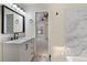 Bathroom with modern vanity featuring sink and updated mirror and lighting at 942 S Walden St # 206, Aurora, CO 80017