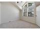 Bright bedroom featuring carpet, vaulted ceilings, and multiple windows for natural light at 942 S Walden St # 206, Aurora, CO 80017