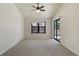 Neutral bedroom with neutral carpet, window, and sliding glass door to outside area at 942 S Walden St # 206, Aurora, CO 80017