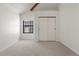 A bedroom featuring neutral carpet, a vaulted ceiling, a window and a sliding-door closet at 942 S Walden St # 206, Aurora, CO 80017