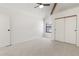 A bedroom with neutral carpet, a vaulted ceiling, a window and a sliding-door closet at 942 S Walden St # 206, Aurora, CO 80017