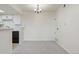 Open dining area with modern chandelier located adjacent to the kitchen at 942 S Walden St # 206, Aurora, CO 80017