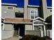 View of the townhome exterior with a stairway leading to the front door and a balcony on the second floor at 942 S Walden St # 206, Aurora, CO 80017