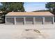 Multiple garages with light gray doors and tan roofing offer plenty of parking space at 942 S Walden St # 206, Aurora, CO 80017