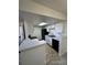 Kitchen featuring white cabinets, black appliances, and modern countertops at 942 S Walden St # 206, Aurora, CO 80017