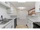 Efficient kitchen featuring white cabinetry, marble countertops, and black appliances at 942 S Walden St # 206, Aurora, CO 80017