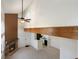 Unique living room with fireplace, fan, beam, and view of kitchen area at 942 S Walden St # 206, Aurora, CO 80017