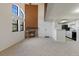 Bright living room shows open floorplan with fireplace and view to kitchen at 942 S Walden St # 206, Aurora, CO 80017
