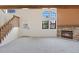 Cozy living room with stone fireplace, staircase, and large windows for natural light at 942 S Walden St # 206, Aurora, CO 80017