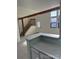 Bright living room with staircase, exposed beam, large window and neutral color palette at 942 S Walden St # 206, Aurora, CO 80017