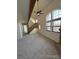 Bright living room with high ceilings, large windows, and a staircase to the upper level at 942 S Walden St # 206, Aurora, CO 80017