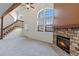 Bright living room with vaulted ceilings, stone fireplace, and large windows at 942 S Walden St # 206, Aurora, CO 80017