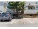 Assigned parking spot, with a parked car and a landscaping feature at 942 S Walden St # 206, Aurora, CO 80017