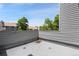 View of surrounding buildings and mature trees from an attached patio at 942 S Walden St # 206, Aurora, CO 80017