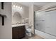 Bathroom with a wood vanity, oval mirror, and tiled shower and bathtub at 7887 S Kittredge Cir, Englewood, CO 80112