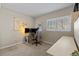 This bedroom is setup as a home office, with large window and neutral carpeting at 7887 S Kittredge Cir, Englewood, CO 80112