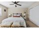 Bright bedroom features neutral walls, ceiling fan, a bed, and natural light from the window at 7887 S Kittredge Cir, Englewood, CO 80112