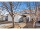 Exterior view of the house with an attached two-car garage and a well-manicured lawn at 7887 S Kittredge Cir, Englewood, CO 80112