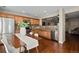 Modern kitchen with stainless steel appliances, wood cabinets, and a view into the living area at 7887 S Kittredge Cir, Englewood, CO 80112