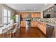 Updated kitchen featuring stainless steel appliances and warm wood cabinetry at 7887 S Kittredge Cir, Englewood, CO 80112