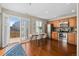 Bright kitchen with stainless steel appliances, wood cabinets, and sliding doors to the backyard at 7887 S Kittredge Cir, Englewood, CO 80112