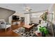 Inviting living room with hardwood floors, a stylish rug, comfortable seating, and a ceiling fan at 7887 S Kittredge Cir, Englewood, CO 80112