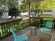Outdoor deck with a seating area and view of the lush green backyard at 9724 W Euclid Dr, Littleton, CO 80123