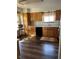 Well-lit kitchen with wooden cabinets, black appliances, and wood-style flooring at 9724 W Euclid Dr, Littleton, CO 80123