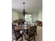 Spacious living room with carpet flooring, dining table and chairs, couch, and sliding glass door to the outside at 9724 W Euclid Dr, Littleton, CO 80123