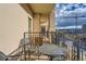Cozy balcony with wrought iron railing and an outdoor seating area featuring cityscape views at 925 N Lincoln St # 8E-S, Denver, CO 80203
