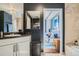 Stylish bathroom showcasing a modern vanity and decor, and a doorway into the bedroom at 925 N Lincoln St # 8E-S, Denver, CO 80203