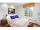 Bright bedroom featuring a plush bed with stylish blue patterned pillows and a sunlit window at 844 N Humboldt St # 5, Denver, CO 80218