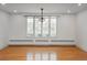 Bright, empty room featuring hardwood floors, large windows, and decorative ceiling trim at 844 N Humboldt St # 5, Denver, CO 80218