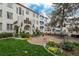 Expansive exterior with stone patio, manicured lawn, and vibrant flower beds offers ample space for outdoor living at 844 N Humboldt St # 5, Denver, CO 80218